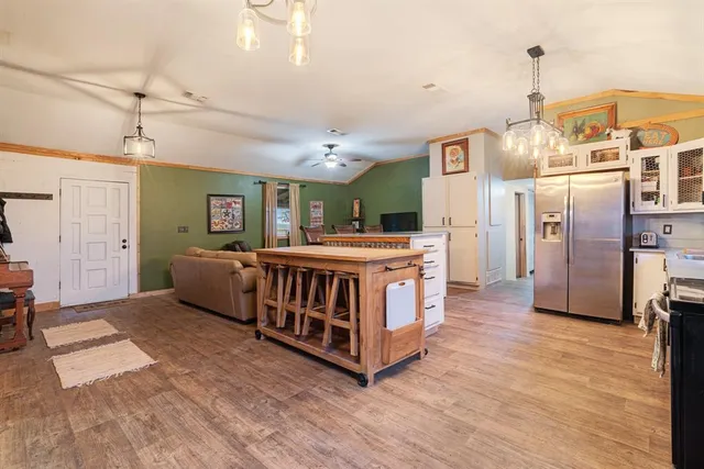 a living room with lots of furniture and a wooden floor