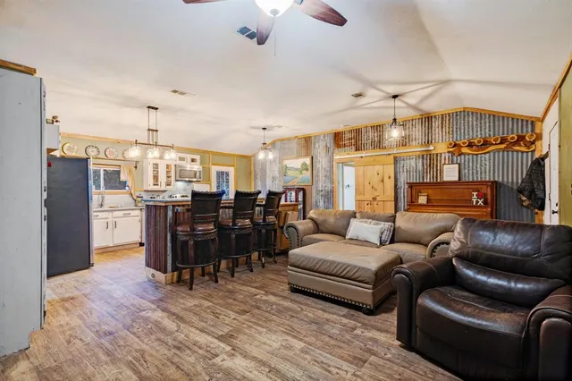 a kitchen with stainless steel appliances granite countertop a sink a stove and a refrigerator