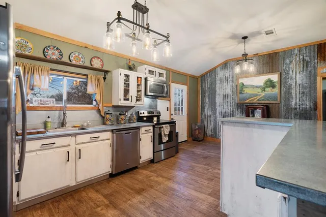 a open kitchen with stainless steel appliances granite countertop a stove and refrigerator