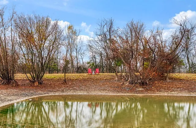 a swimming pool with outdoor seating and yard