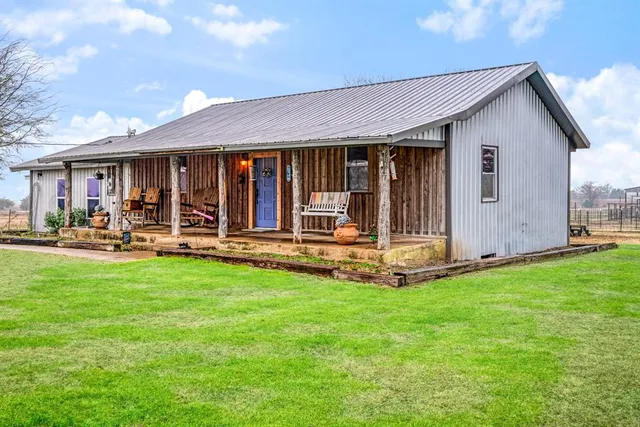 a view of a house with backyard and porch