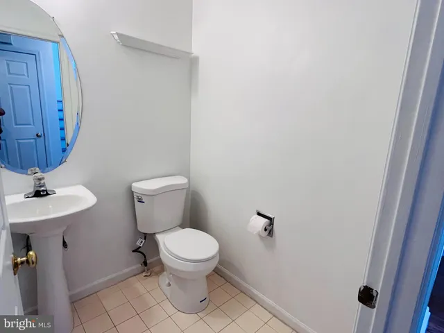 a white toilet sitting next to a bathroom sink