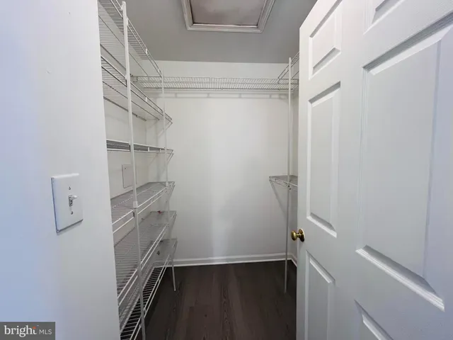 a view of walk in closet with empty racks