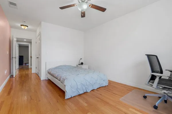 a bedroom with a bed and a chair