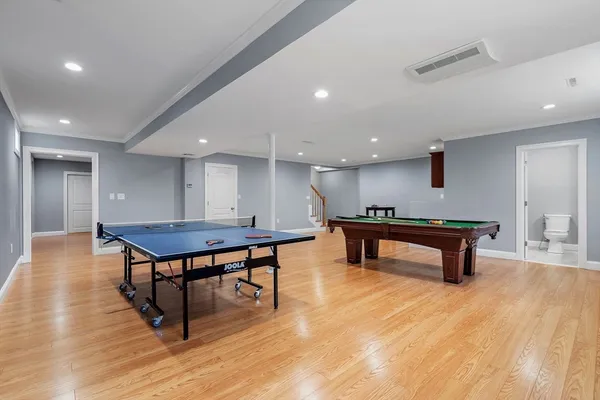 a room with wooden floor pool table table tennis table