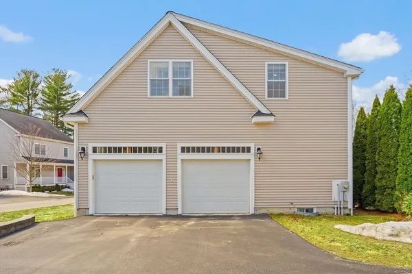 a view of a house with a yard and garage