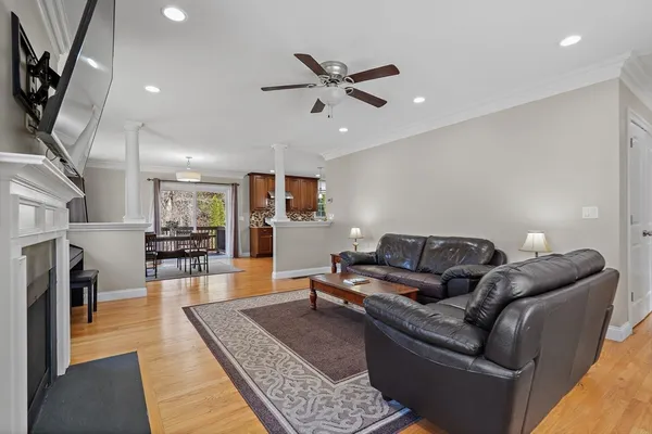a living room with furniture and a wooden floor