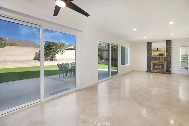 a view of livingroom with floor to ceiling window and a ceiling fan