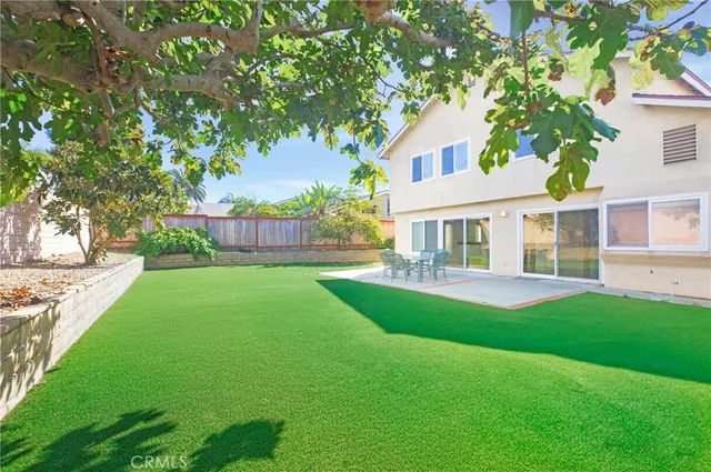 a front view of a house with a yard table and chairs