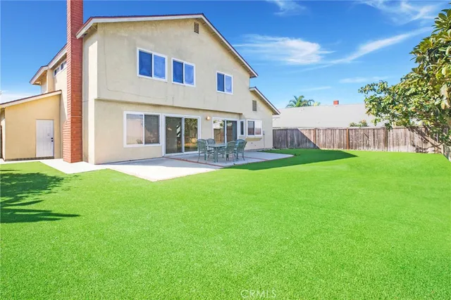 a front view of house with yard and outdoor seating
