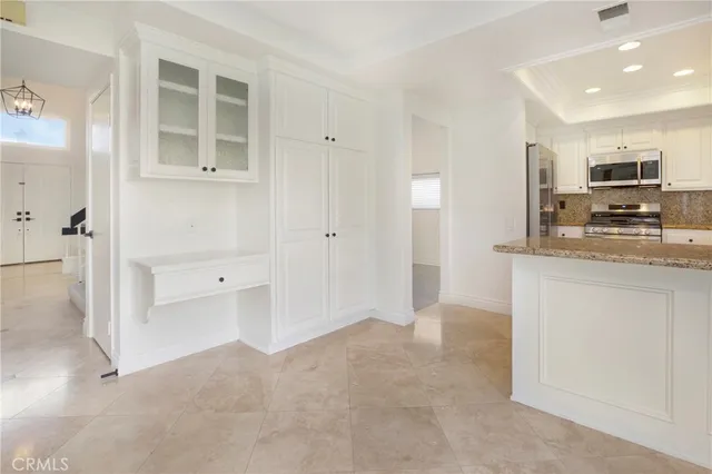 a view of kitchen with kitchen island wooden floor and refrigerator