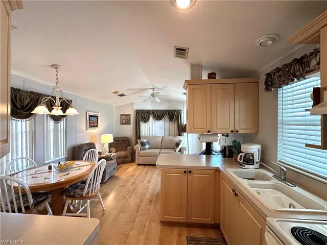 a room with stainless steel appliances a stove a sink and a refrigerator