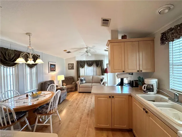 a kitchen with a sink a stove and cabinets