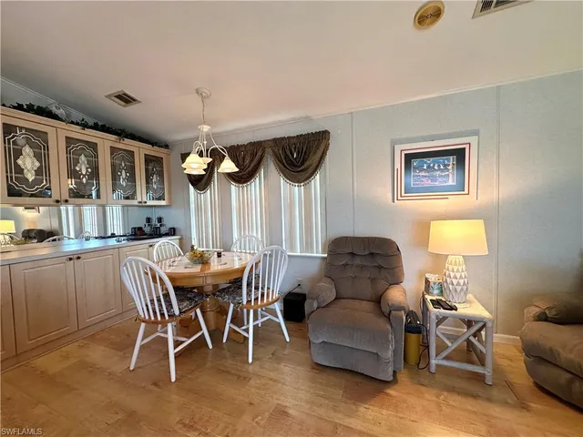 a living room with furniture a window and a chandelier