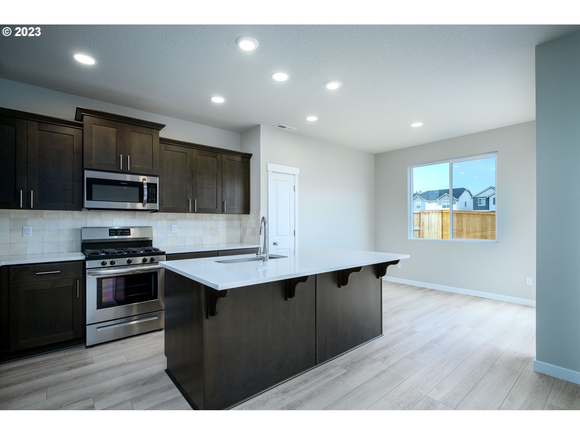 3162 South Magnolia Street, Unit LT754 Cornelius, OR 97113 - Photo 12 of 40 a kitchen with stainless steel appliances granite countertop a stove a sink dishwasher and a refrigerator