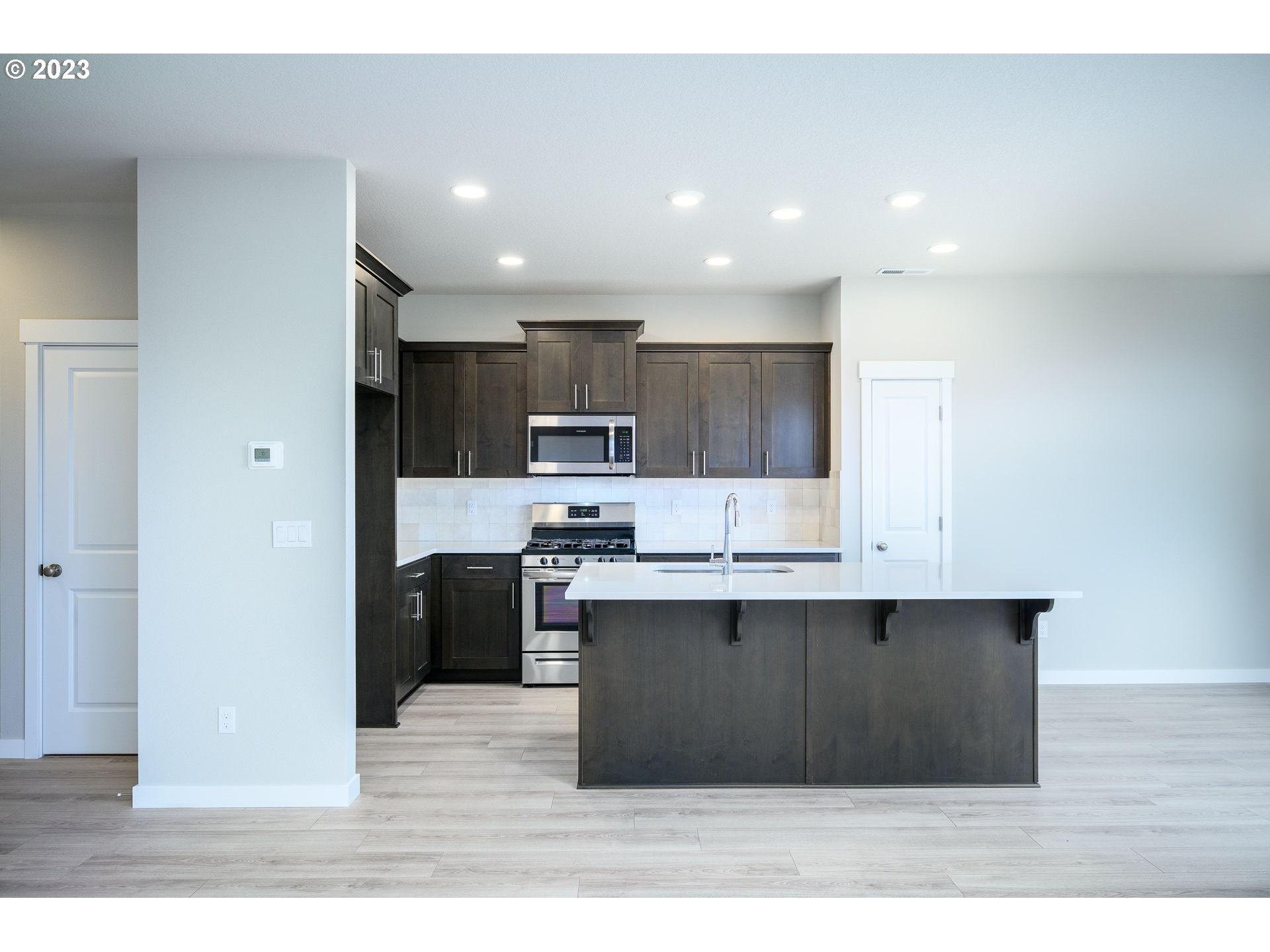 3162 South Magnolia Street, Unit LT754 Cornelius, OR 97113 - Photo 13 of 40 a kitchen with kitchen island sink stainless steel appliances and cabinets