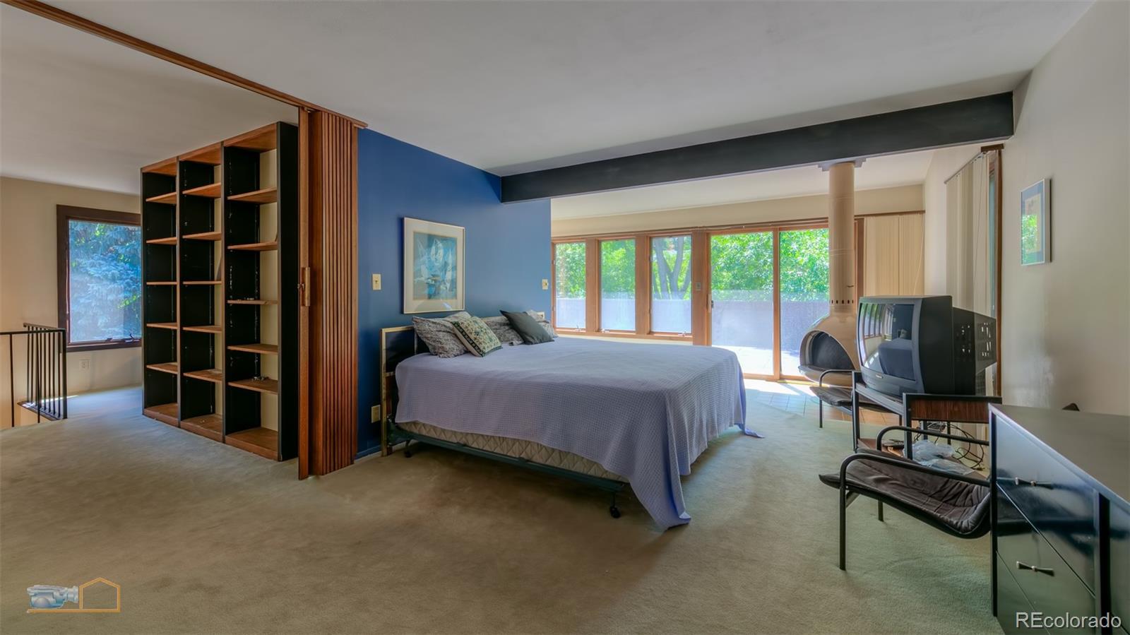 1425 Bellevue Drive Boulder, CO 80302 - Photo 15 of 40 a bedroom with a bed and a flat tv screen next to a large window