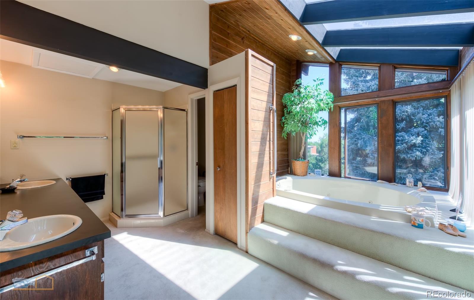 1425 Bellevue Drive Boulder, CO 80302 - Photo 17 of 40 a spacious bathroom with a granite countertop sink and a large mirror
