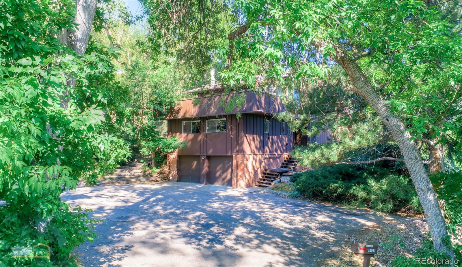 1425 Bellevue Drive Boulder, CO 80302 - Photo 3 of 40 a view of a backyard with plants and large trees