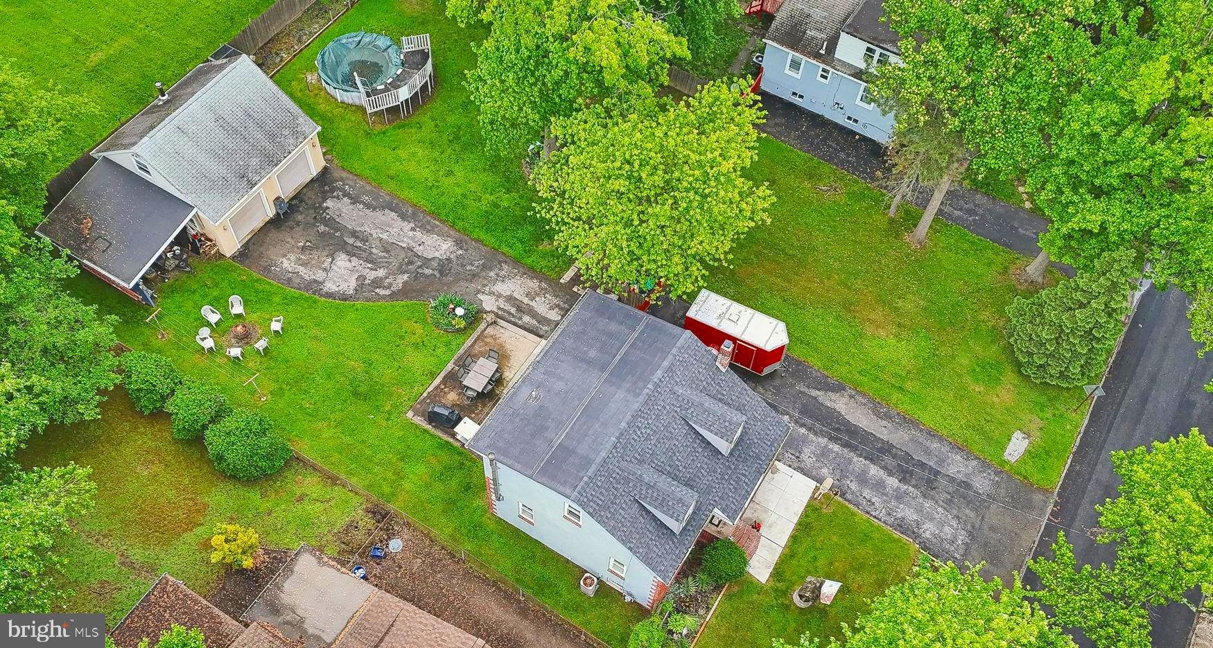 an aerial view of a house with pool yard and outdoor seating