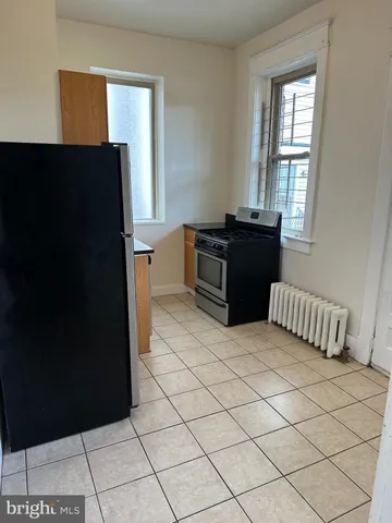 a kitchen with a refrigerator and a stove top oven