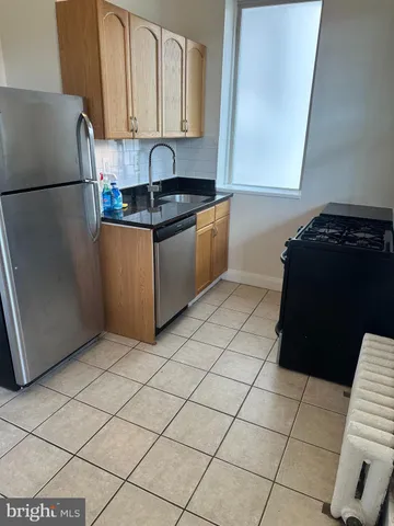 a kitchen with a sink and a refrigerator