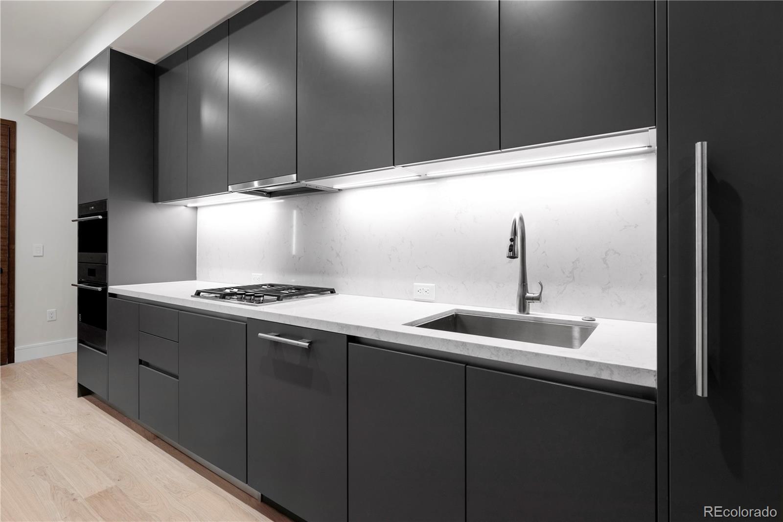 1901 Wazee Street, Unit 311 Denver, CO 80202 - Photo 9 of 17 a kitchen with a sink and a refrigerator