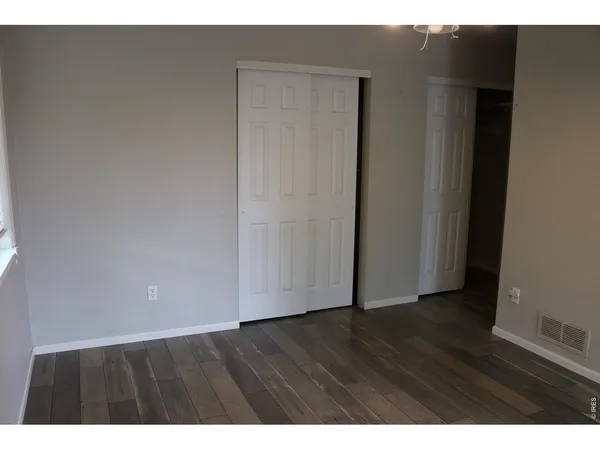 a view of an empty room and wooden floor