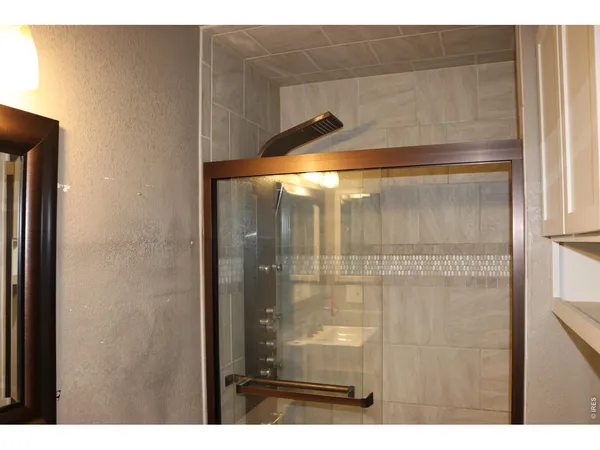 a bathroom with a glass shower door