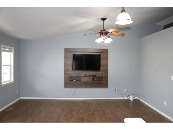 a living room with a flat screen tv and a fireplace