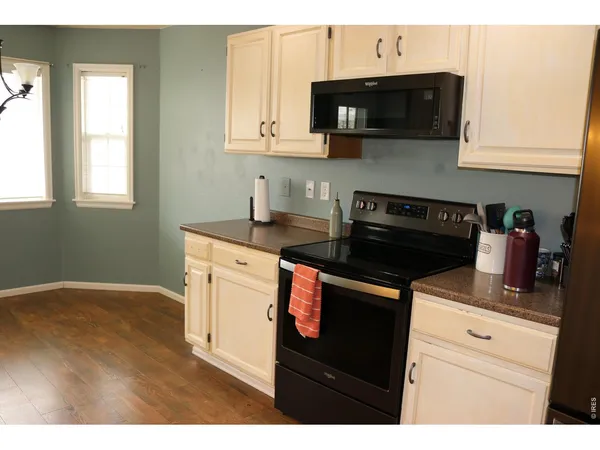 a kitchen with stainless steel appliances granite countertop a sink a stove a microwave and cabinets