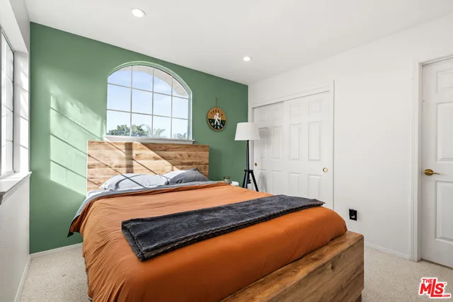 a bedroom with a bed and a window