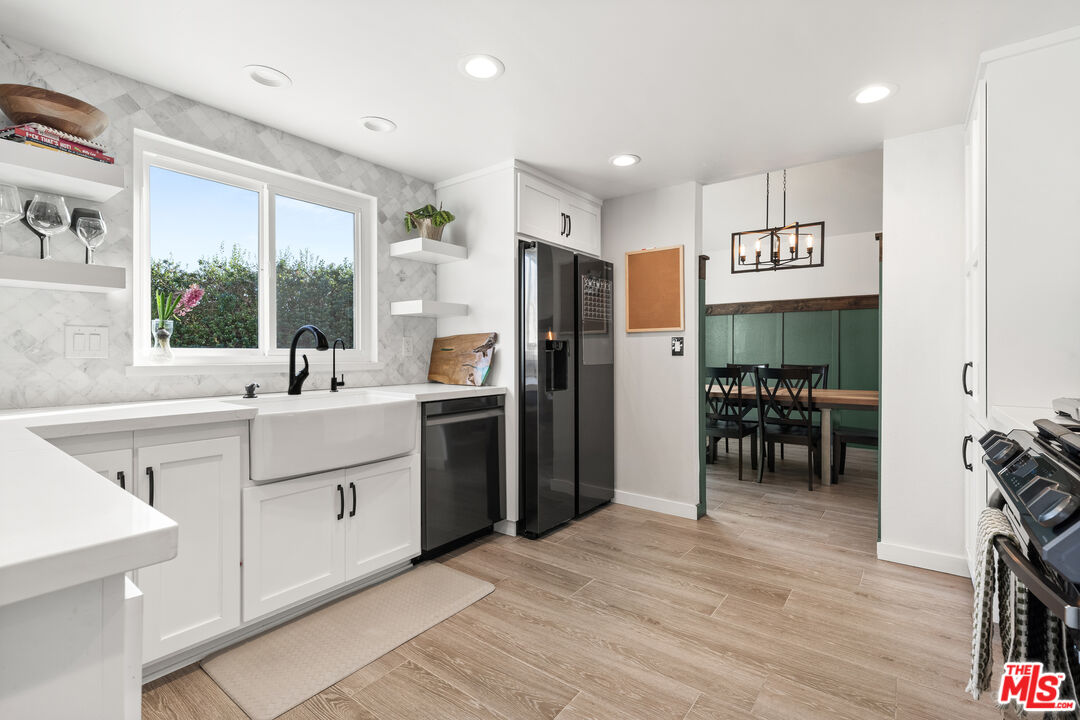 824 Cooper Drive Lompoc, CA 93436 - Photo 8 of 24 a kitchen with stainless steel appliances kitchen island granite countertop a refrigerator and a sink