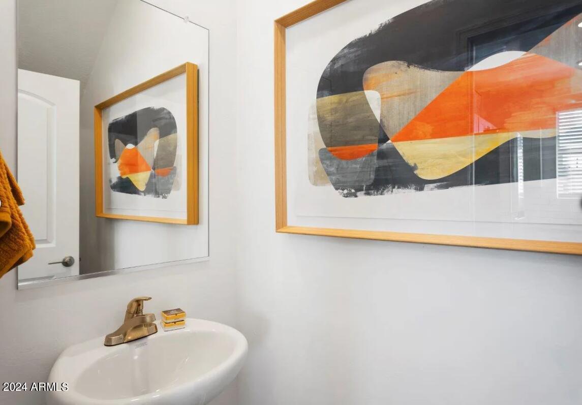 16520 North Greasewood Street, Unit 3 Surprise, AZ 85378 - Photo 14 of 16 a bathroom with a sink and mirror