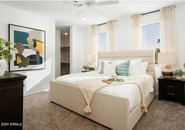 a bedroom with a bed and a painting on the wall