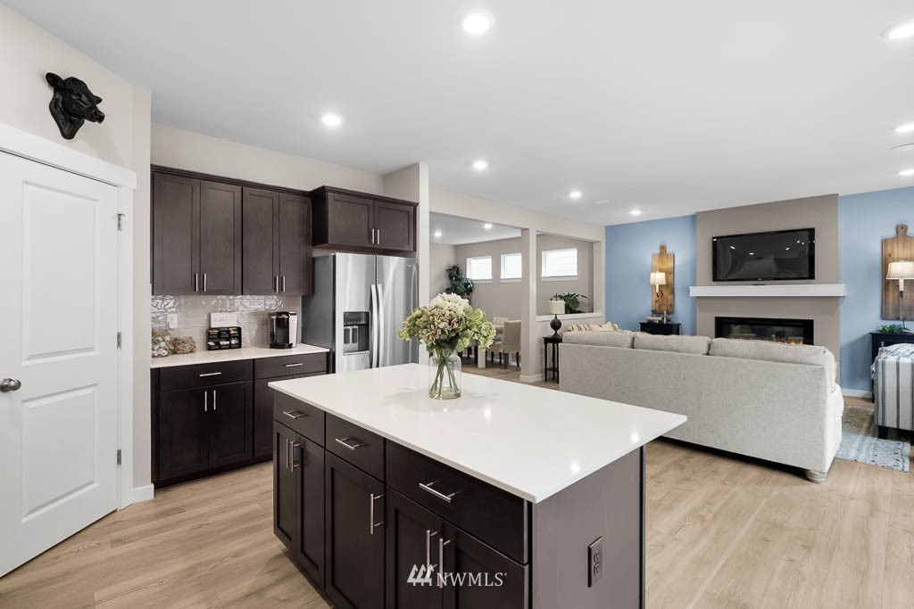 26 180th Place Southwest, Unit 25 Bothell, WA 98012 - Photo 14 of 39 a kitchen with kitchen island a counter top space a sink stainless steel appliances and cabinets