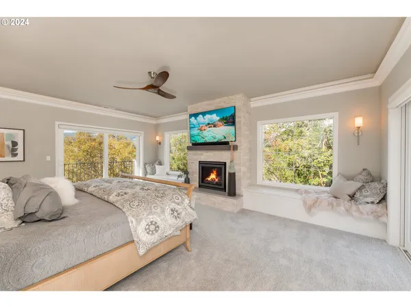 a spacious bedroom with a large bed and a fireplace