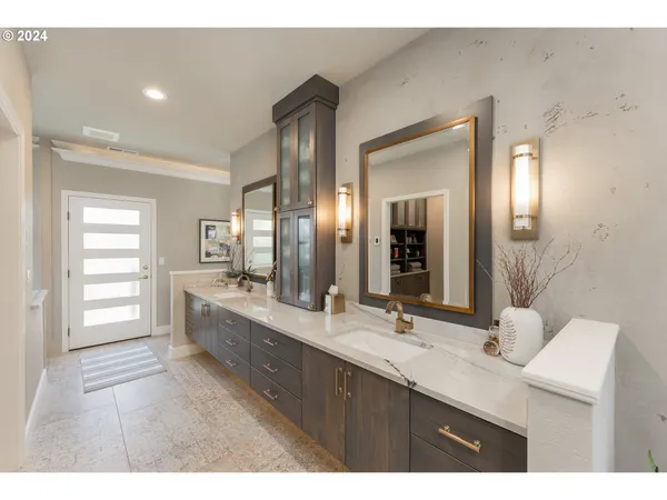 a bathroom with a double vanity sink and a mirror