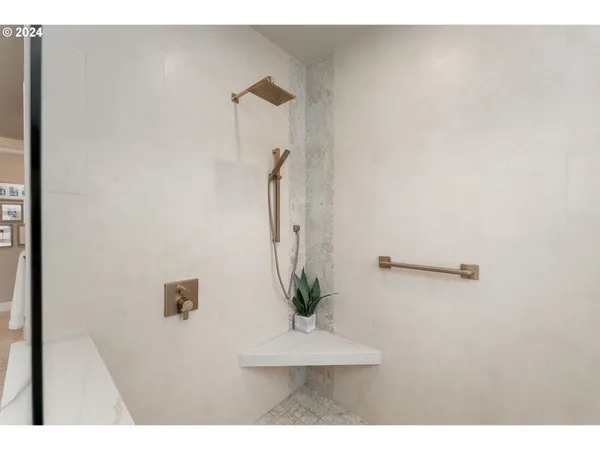 a view of a living room with a white wall and a potted plant