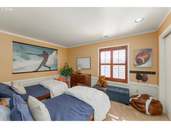 a bedroom with a bed and dresser with mirror