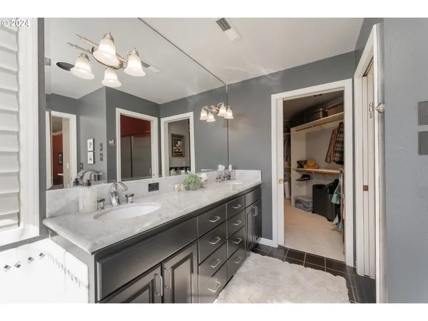 a bathroom with a sink vanity and a mirror