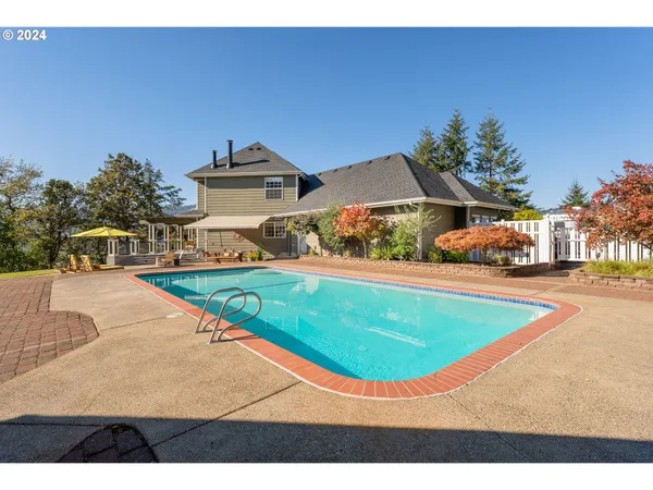 a view of a swimming pool with a yard