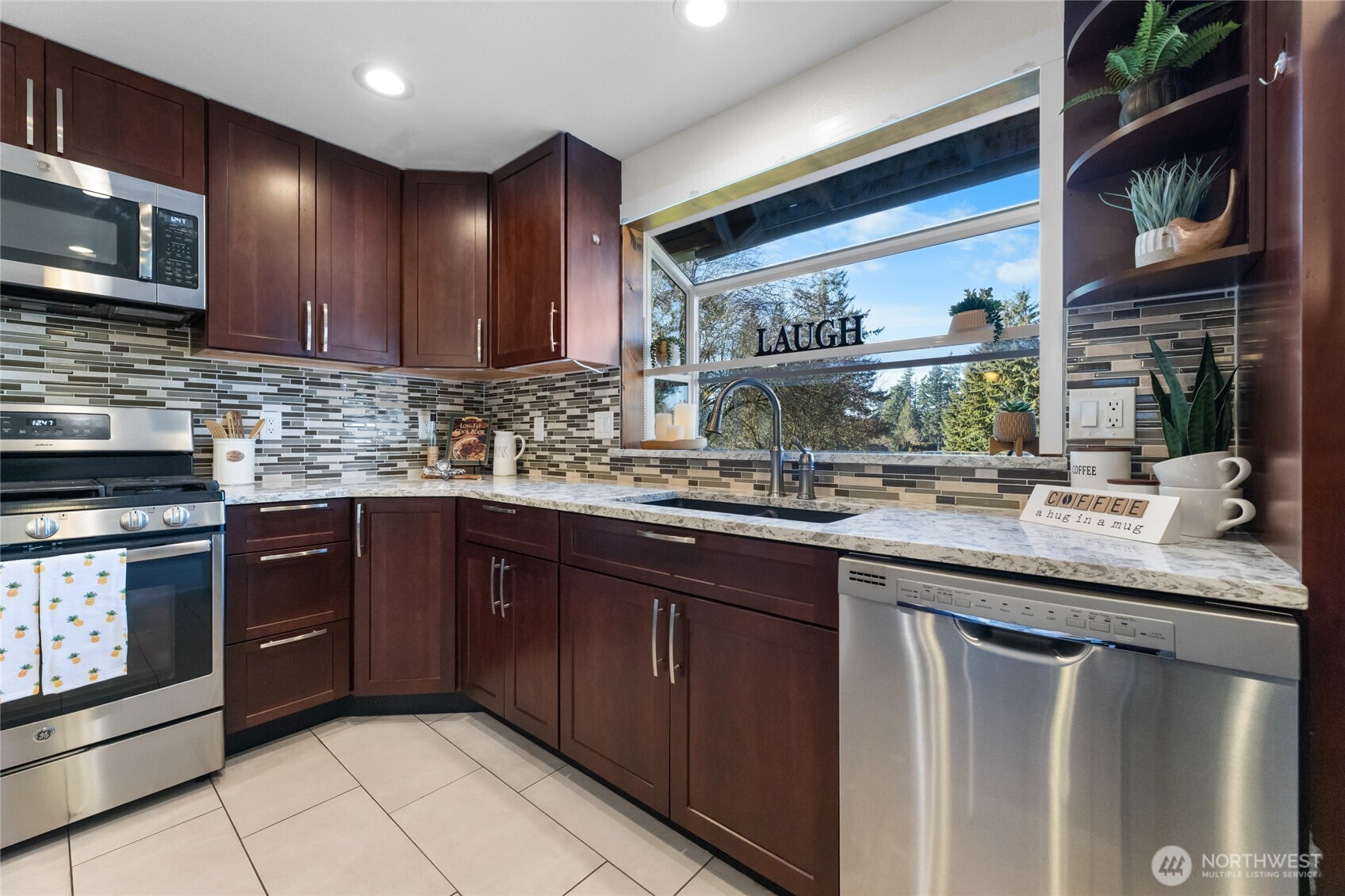 25847 185th Place Southeast Covington, WA 98042 - Photo 7 of 17 a kitchen with stainless steel appliances granite countertop a sink and stove top oven