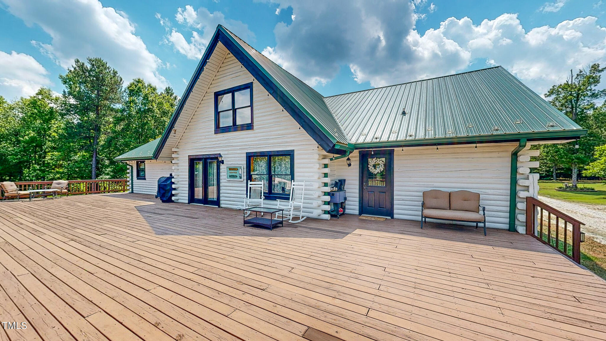 9529 Hester Road Hurdle Mills, NC 27541 - Photo 11 of 85 a view of a house with wooden deck and a garden