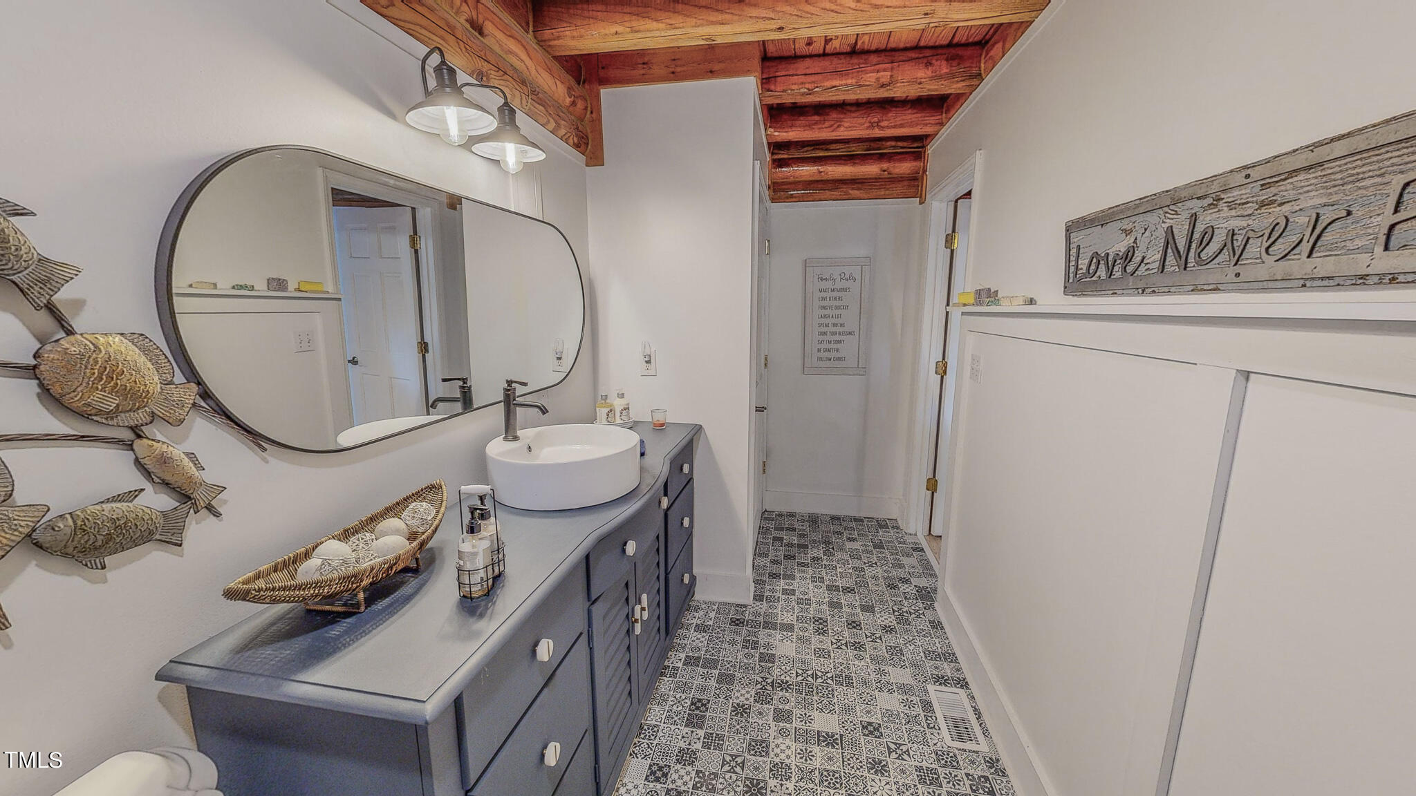 9529 Hester Road Hurdle Mills, NC 27541 - Photo 55 of 85 a bathroom with a sink a toilet and a mirror