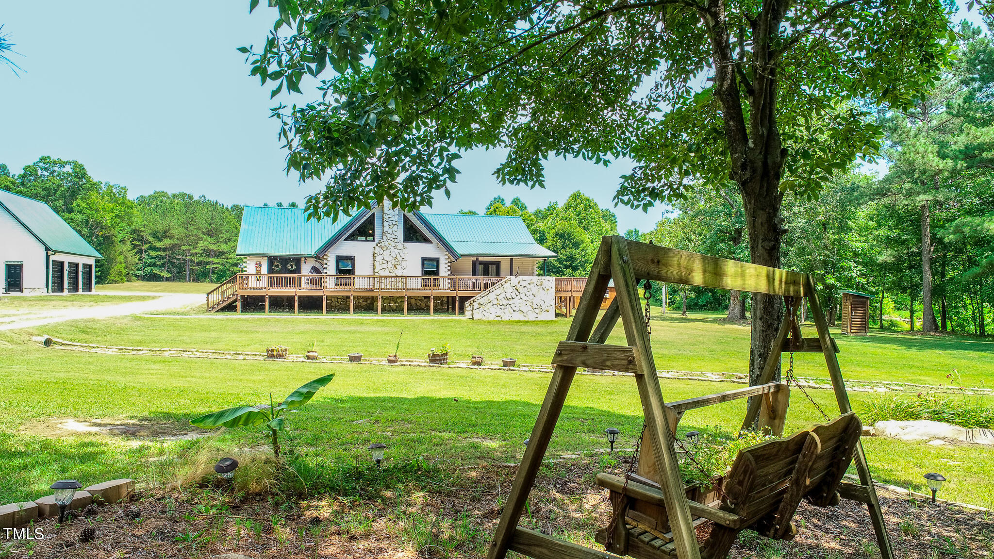 9529 Hester Road Hurdle Mills, NC 27541 - Photo 56 of 85 a view of an house with backyard and a slide