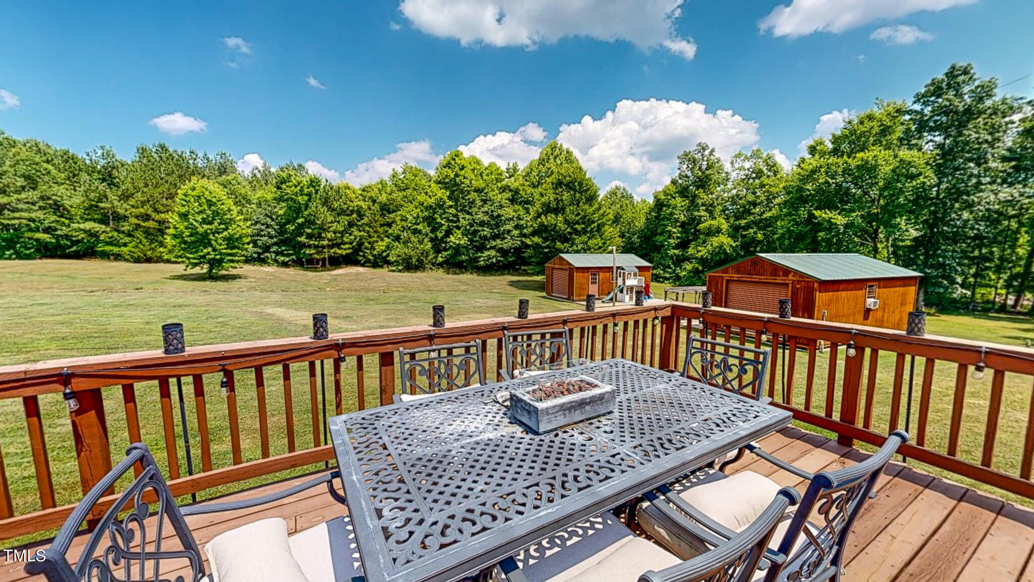 9529 Hester Road Hurdle Mills, NC 27541 - Photo 60 of 85 a balcony of a house with wooden floor and outdoor seating