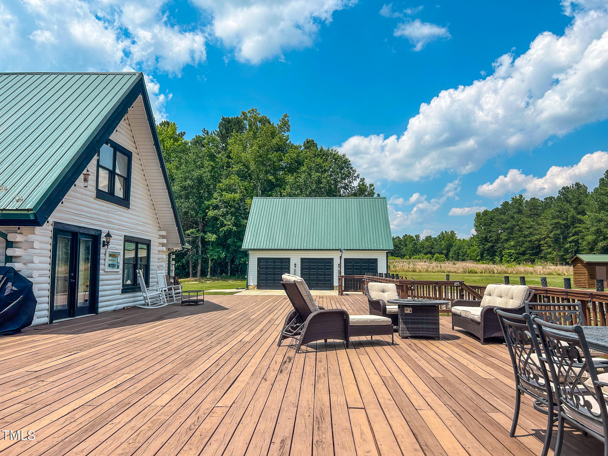 9529 Hester Road Hurdle Mills, NC 27541 - Photo 66 of 85 a view of a patio with dining table and chairs with wooden floor