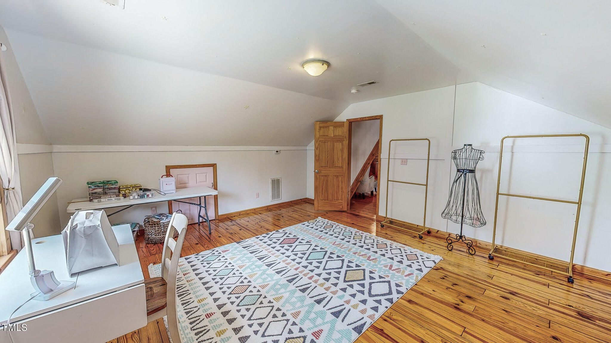 9529 Hester Road Hurdle Mills, NC 27541 - Photo 77 of 85 a bedroom with a bed and a refrigerator