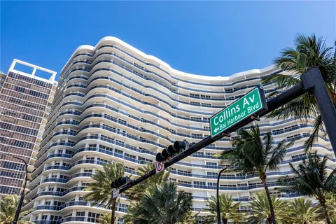 a close up of a palm plant in front of a building